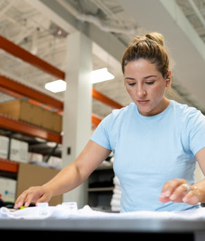 CheaterTee team member folding pretreated garments.